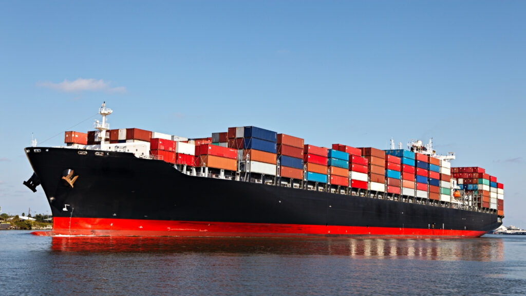 Cargo Ship with stacks of containers arriving at a port of call