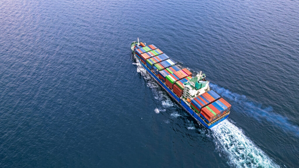 Cargo ship with containers sailing acress the open seas