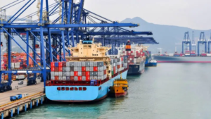 Cargo shops docked at a port of call to upload containers
