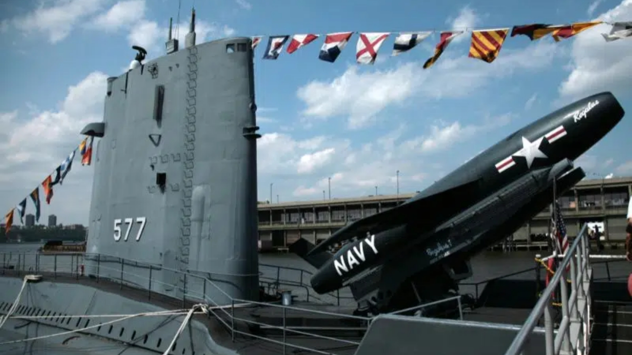 Flags on a US Navy submarine docking at a port