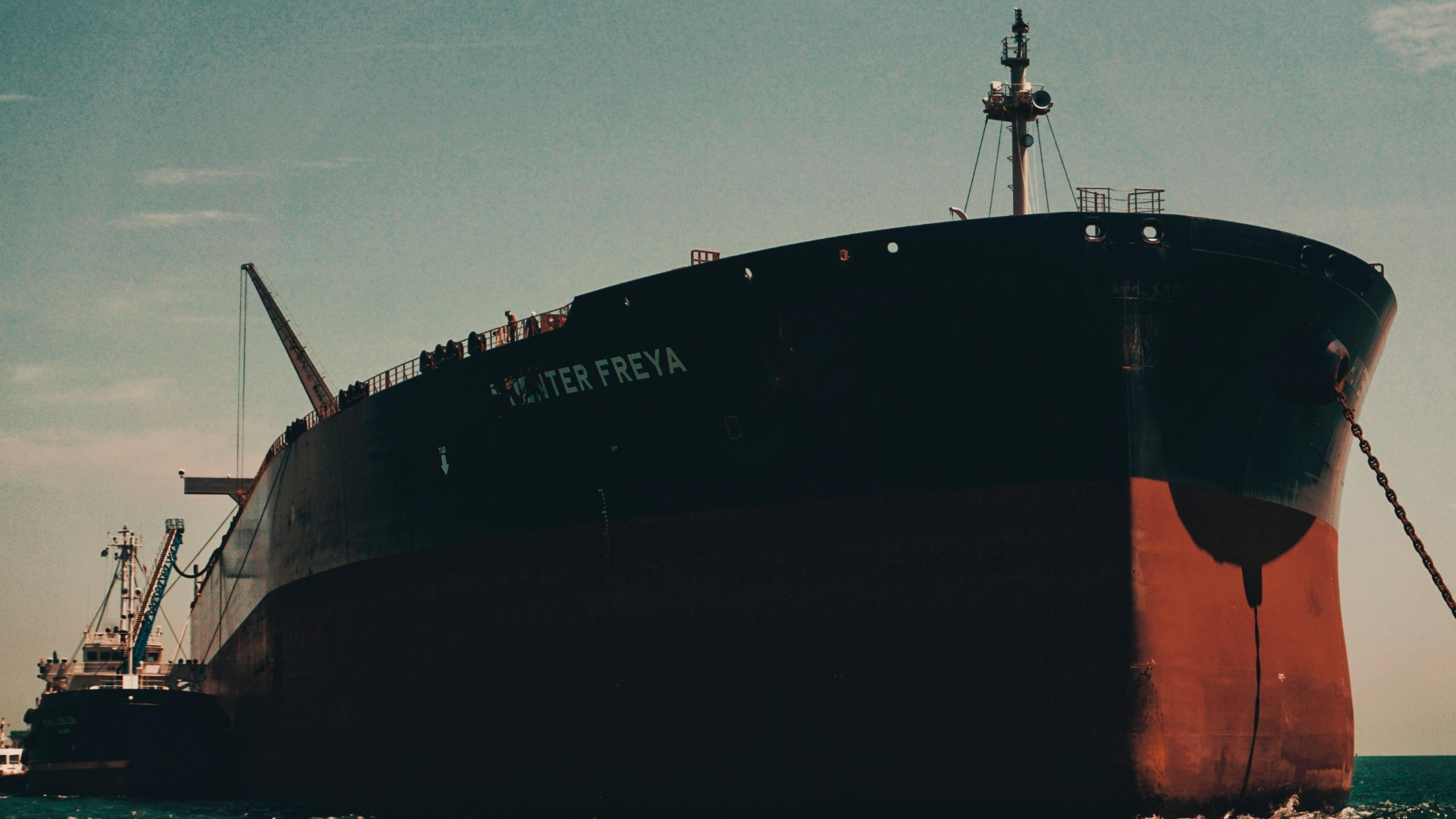 Large Ship named Oliter Freya docked at a port of call