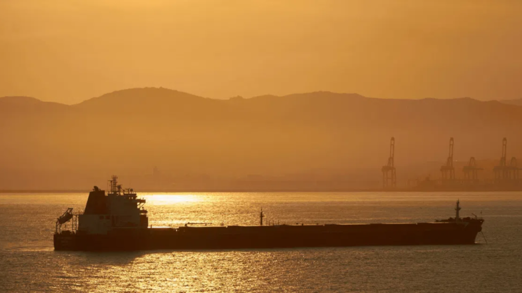 Oil tanker sailing in the open sea at dawn