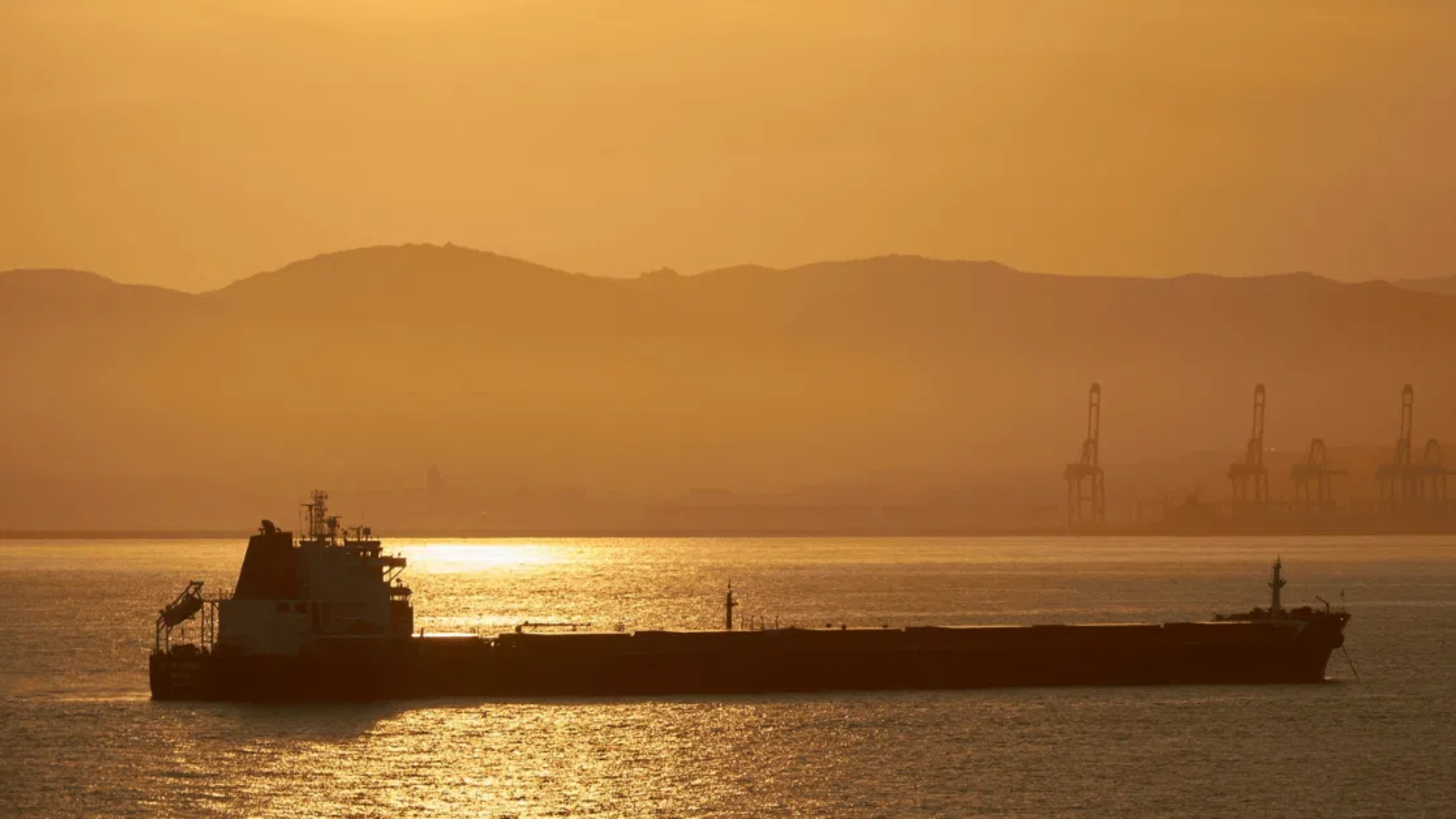 Oil tanker sailing in the open sea at dawn