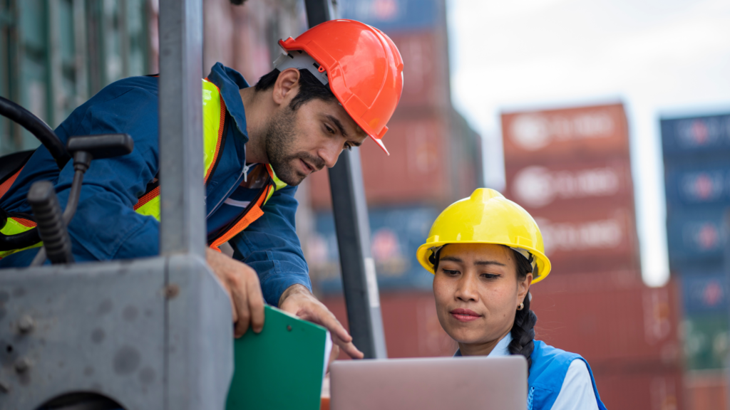 Port worker supervisor checking on containers stocks
