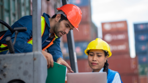 Port worker supervisor checking on containers stocks