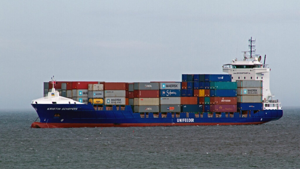 Cargo ship carrying containers saling in the open seas