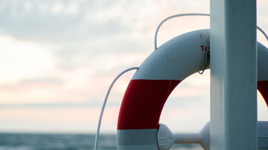 Life saving buoy hung on a ship pole