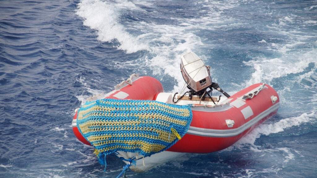 Life saving boat tied to a ship