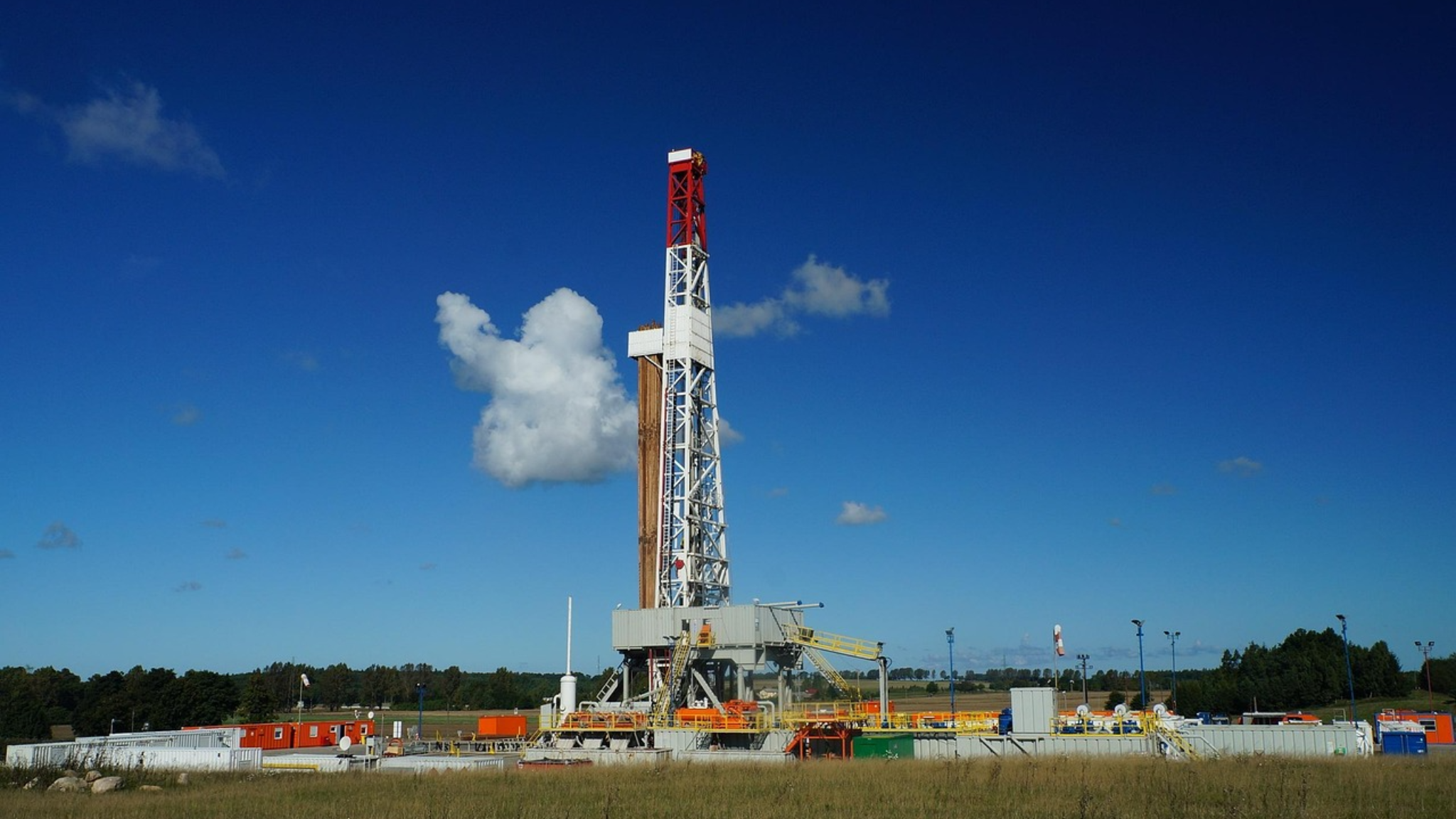 Offshore drilling rig against a blue sky, representing offshore oil and gas operations in Southeast Asia