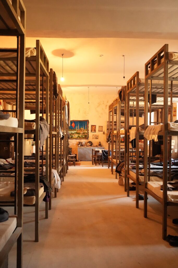 A long dormitory hall lined with bunk beds