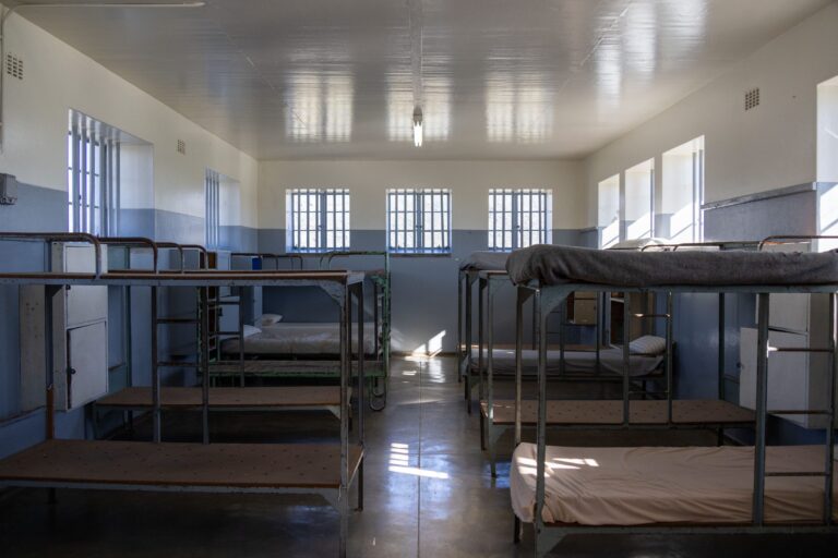 Clean, well-lit worker dormitory room with bunk beds
