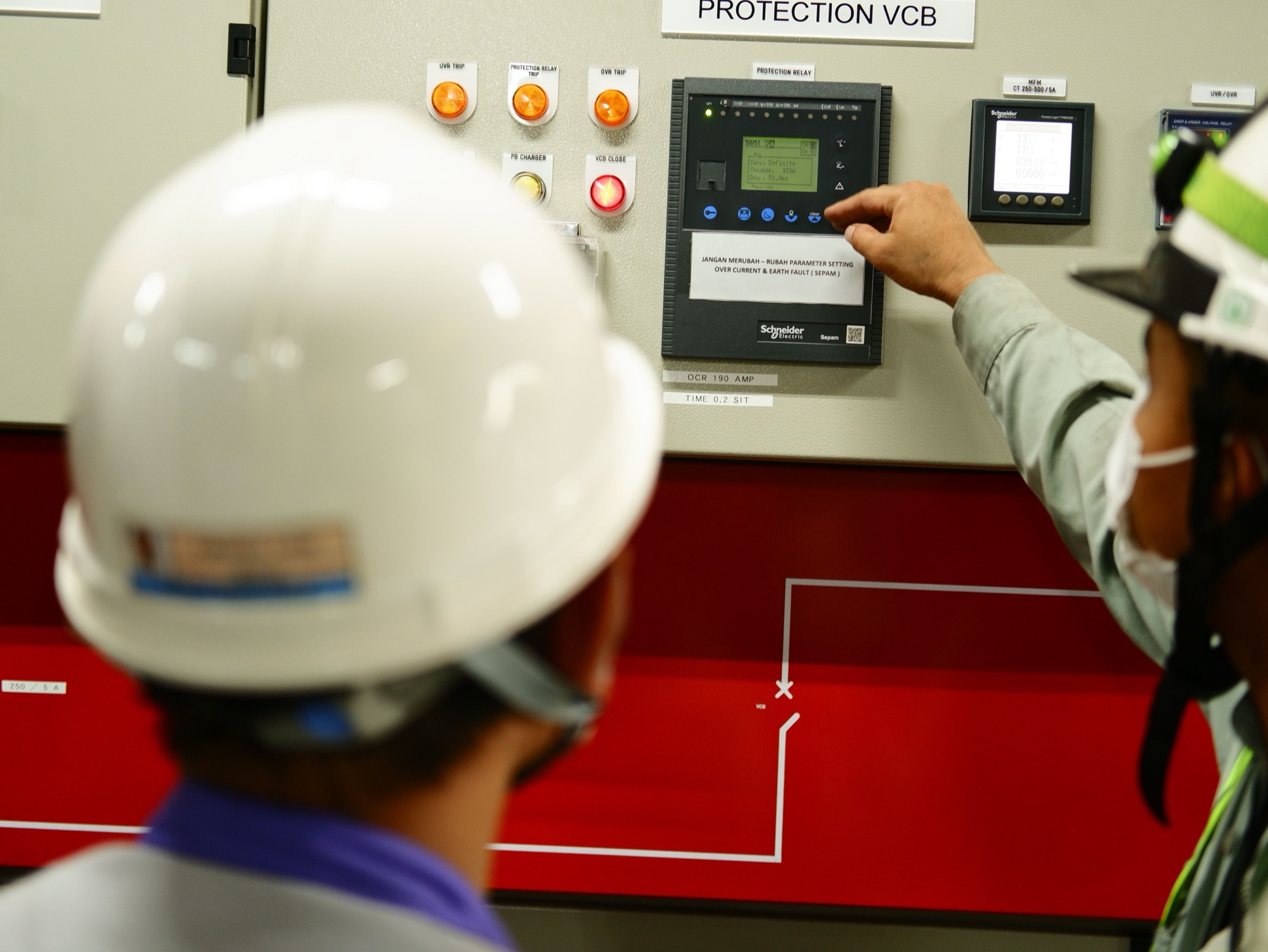 Technician at a protection panel