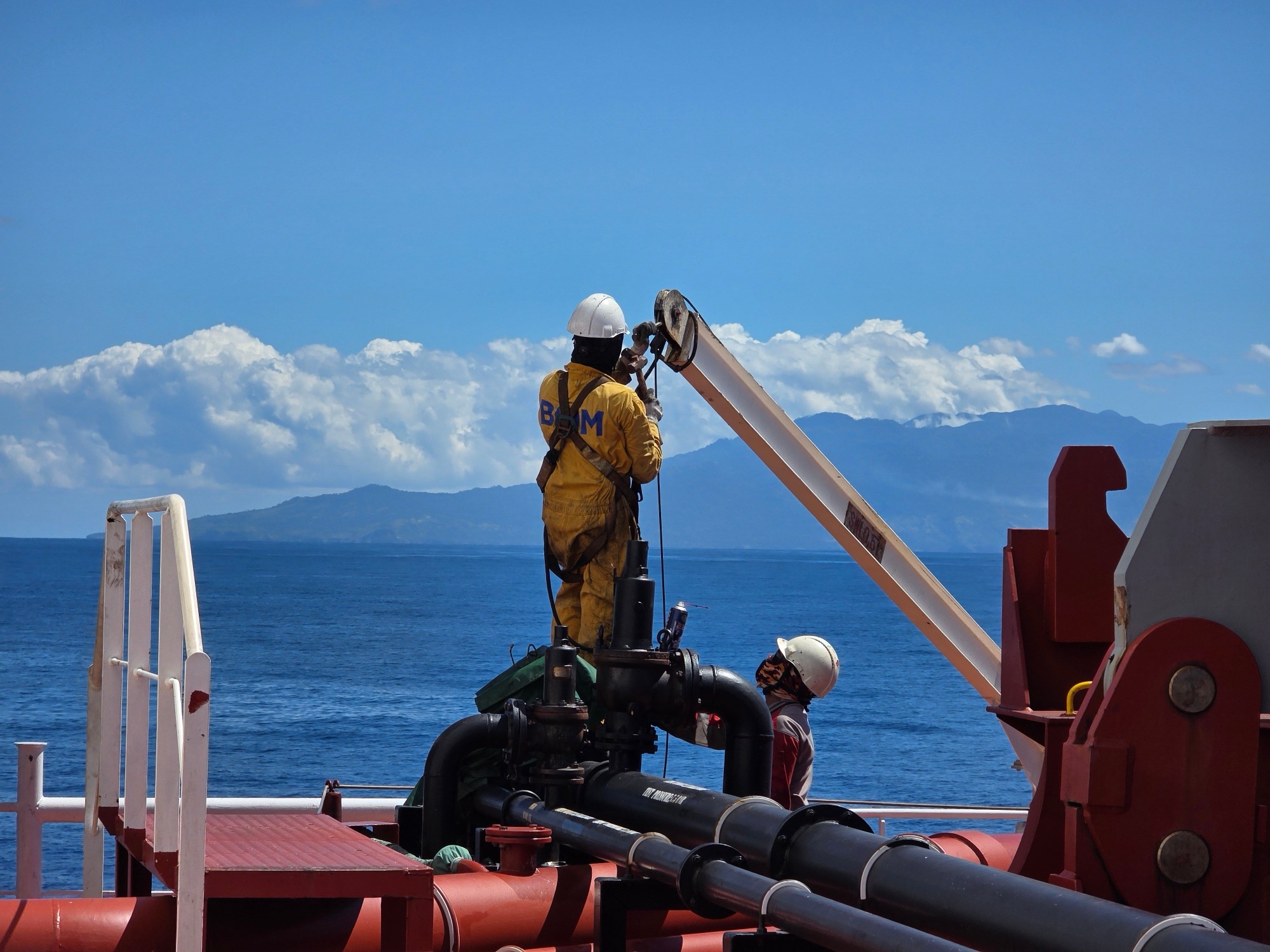 Crew at the rail of an offshore vessel