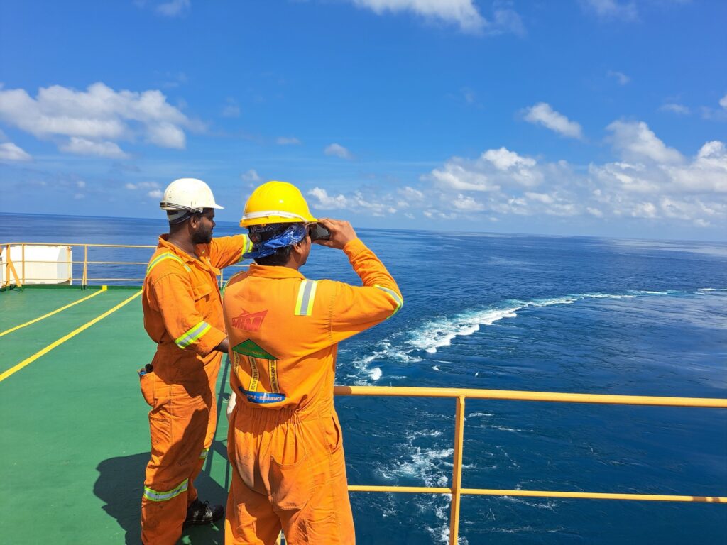 Crew looking out from an offshore deck