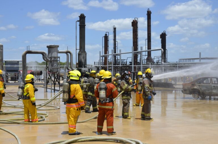 Firefighters working hose lines at an industrial site