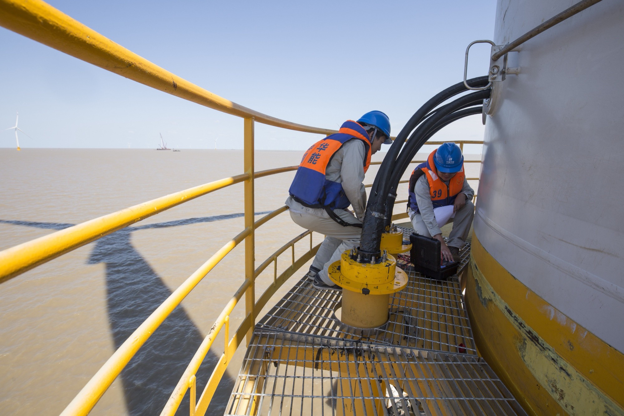 Worker on an offshore walkway